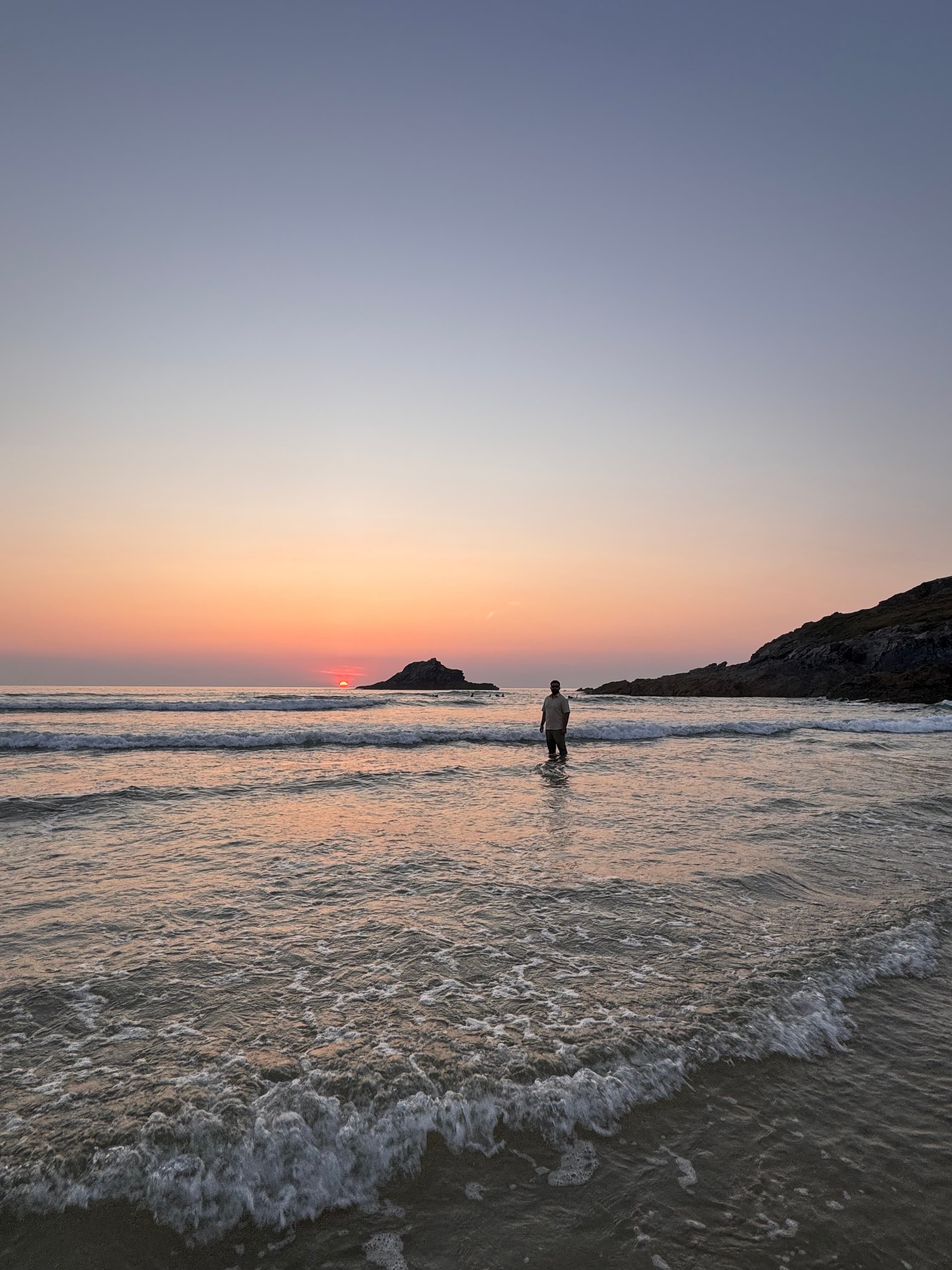 Aoun Hussain standing at the shoreline at sunset